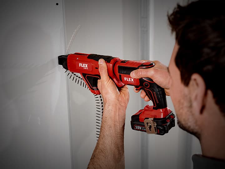 Screwing in plasterboards with a cordless drywall screwdriver