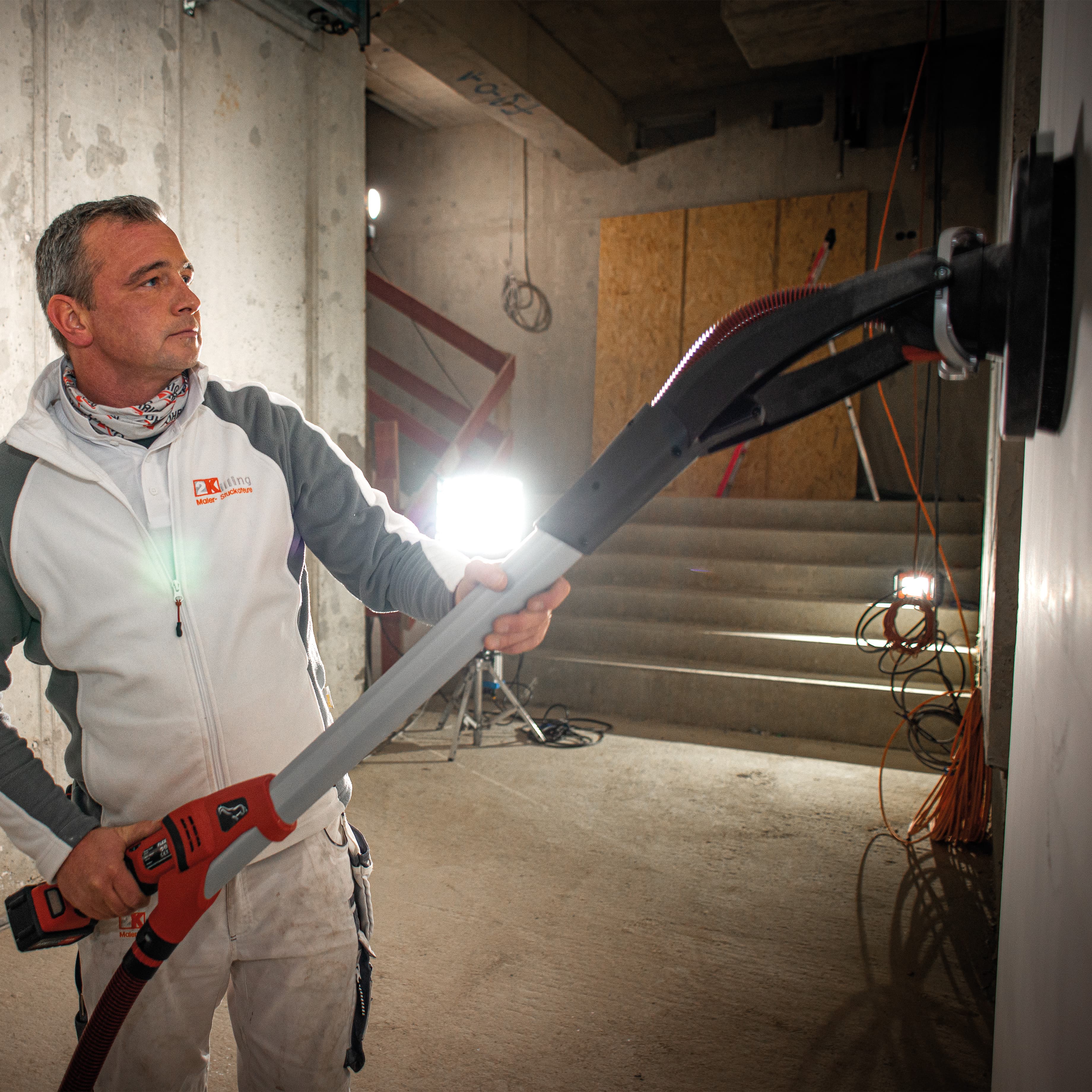Drywall sanding on a construction site with a cordless Giraffe